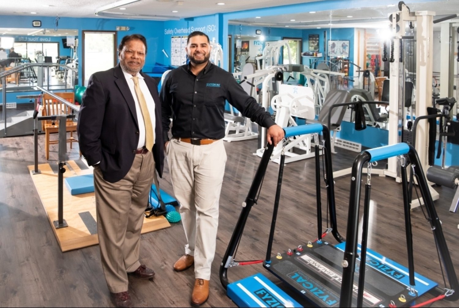 Two generations of the Baig family standing inside the rehabilitation facility
