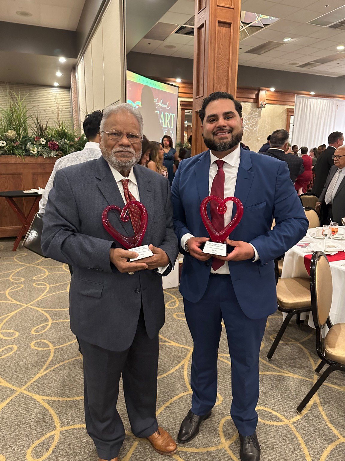 Two generations holding community awards