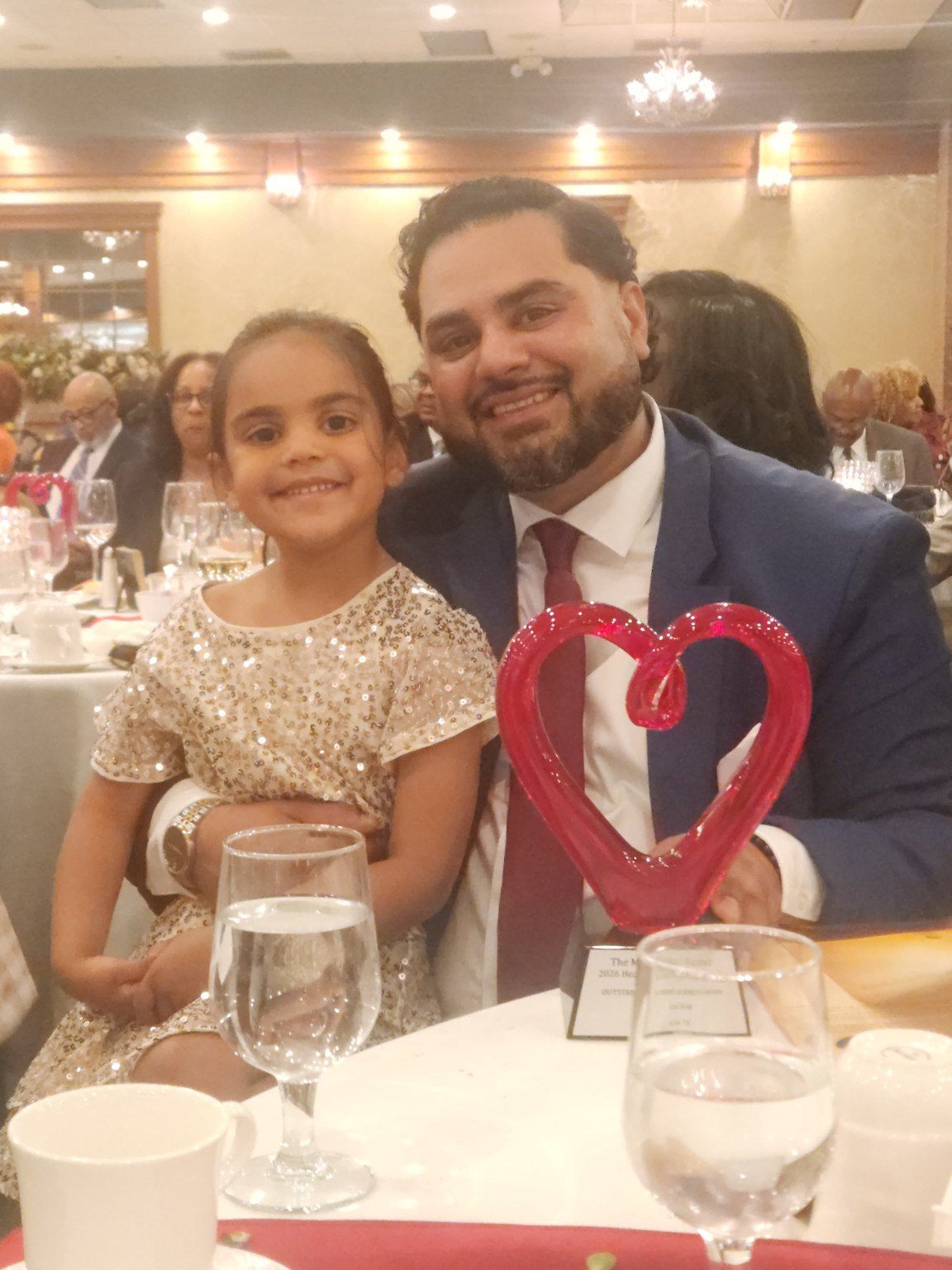 Founder with his daughter and award