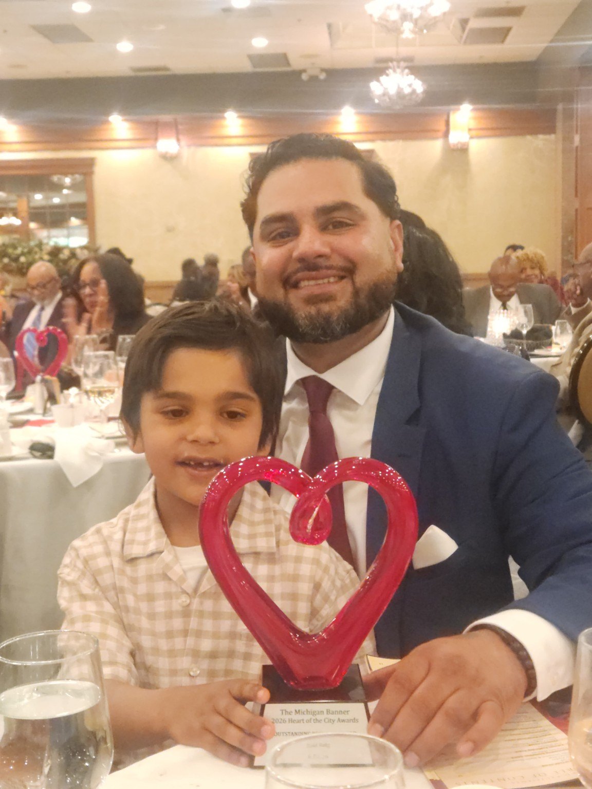 Founder with his son and award