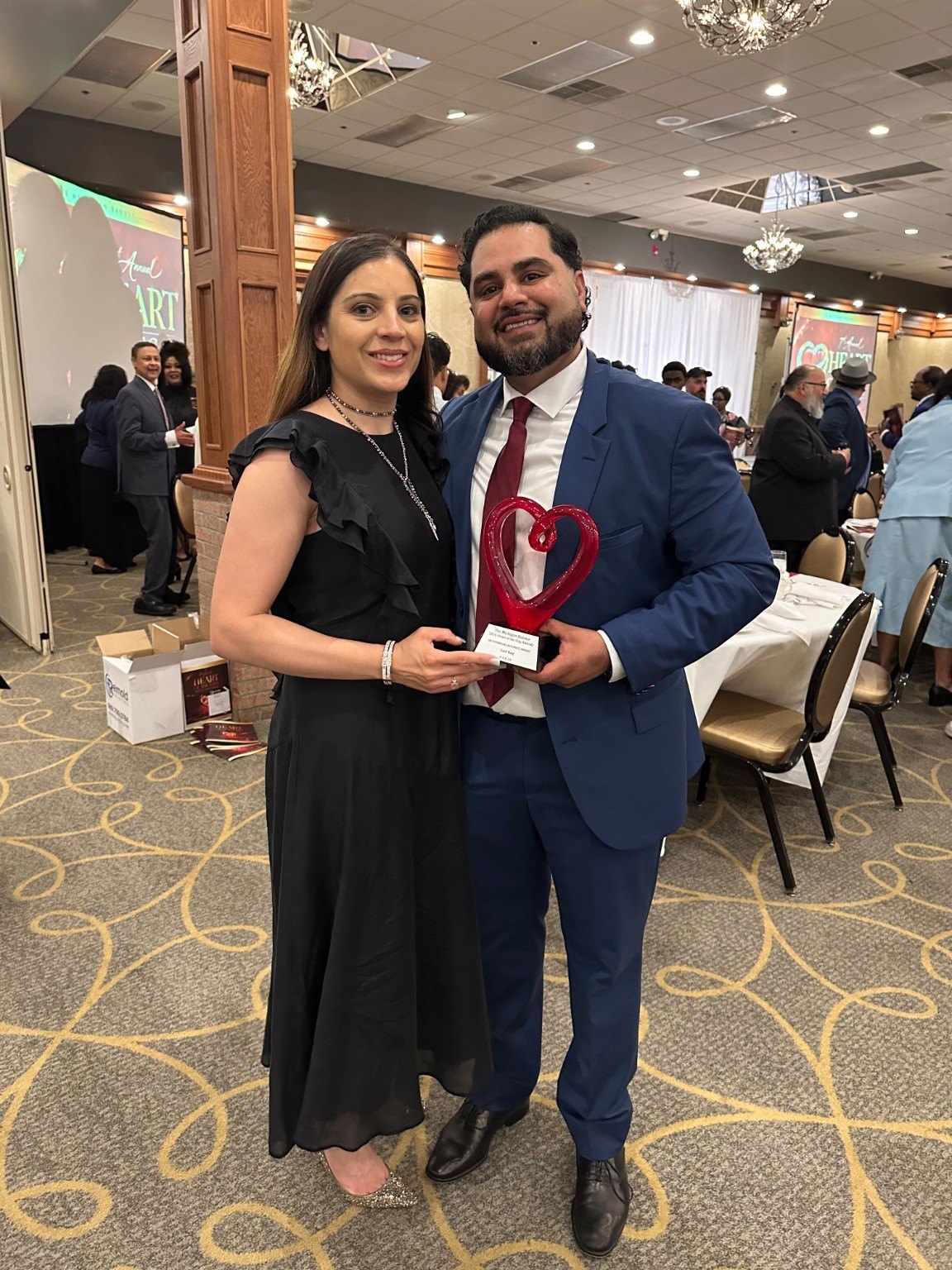 Founder and spouse holding an award